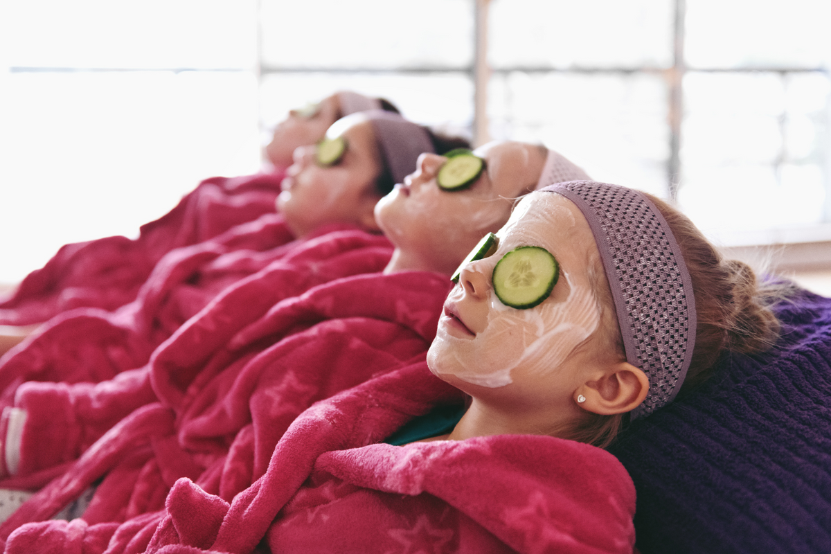 DIY Spa Pamper Party birthday sleepover with girls enjoying spa face masks and cucumber slices